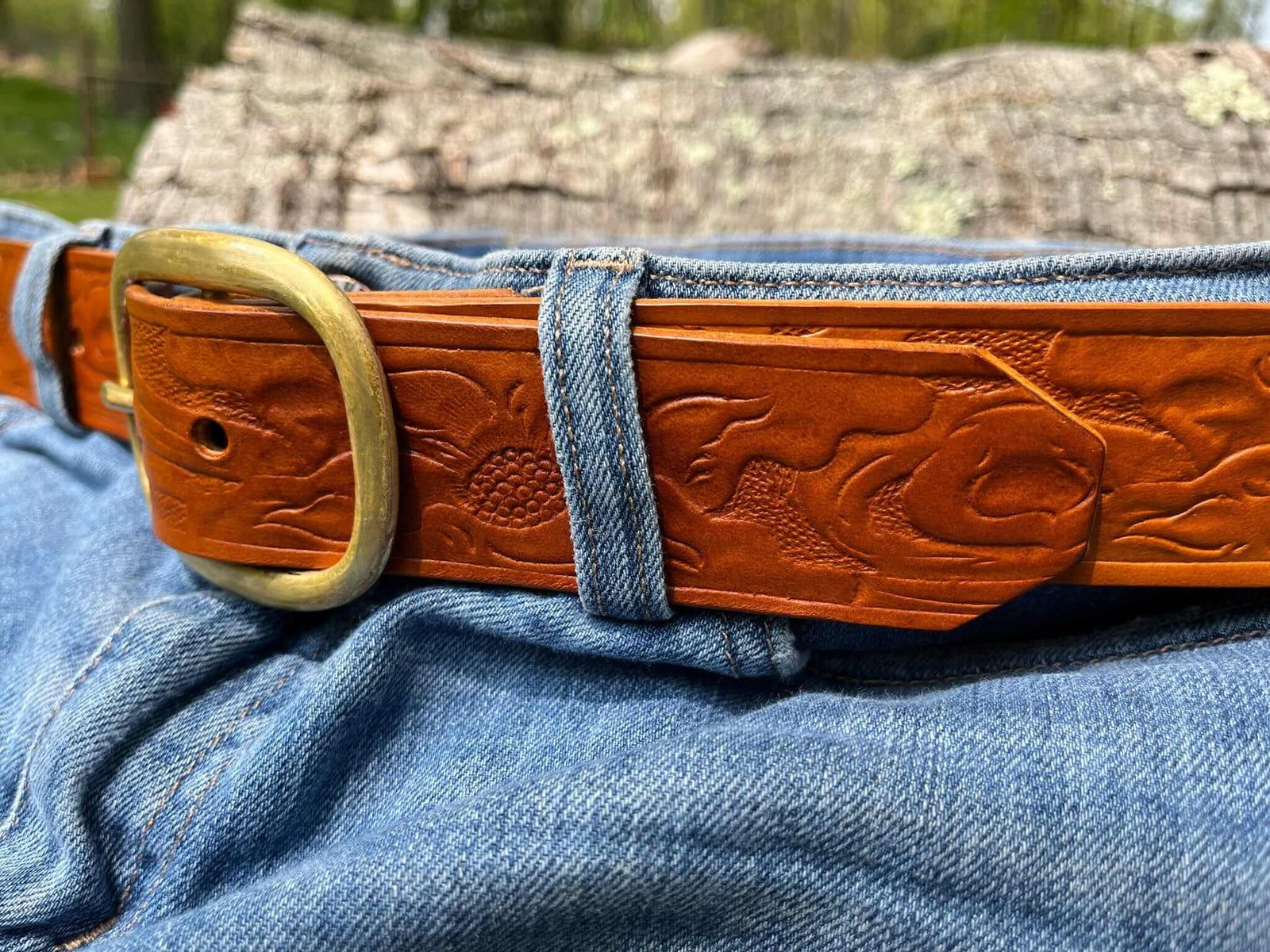 Detail of Embossed Western leather belt with solid brass buckle