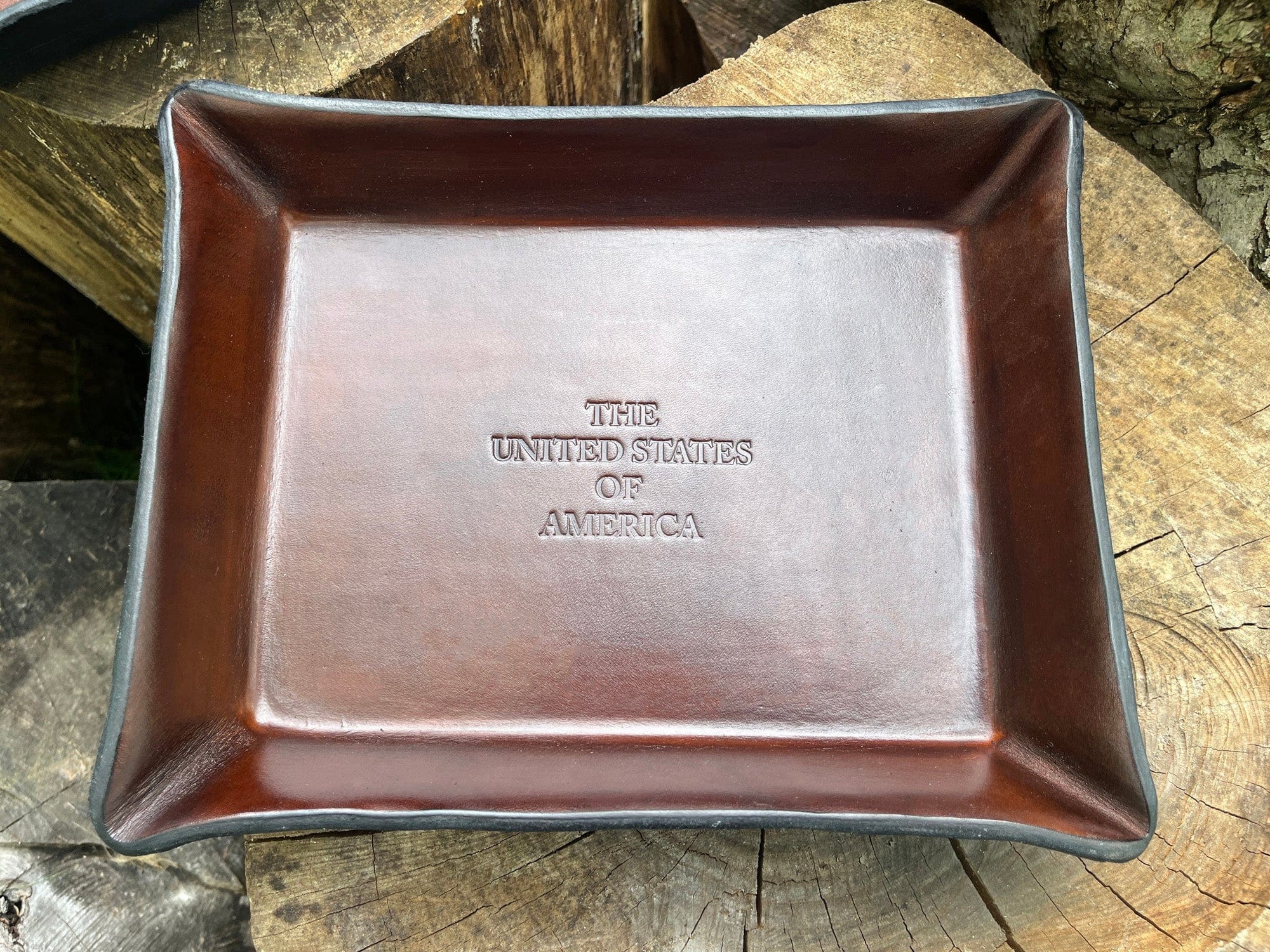 American handcrafted valet tray embossed with "The United States of America". Dark brown.