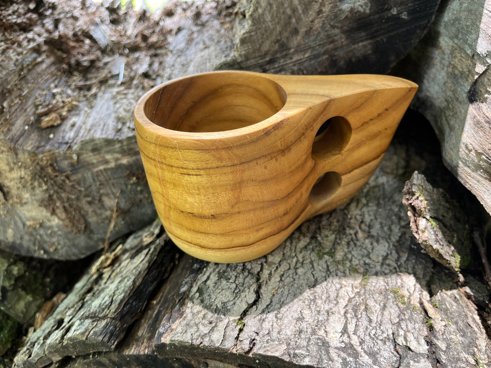 hand carved teak Kuksa mug shown outside