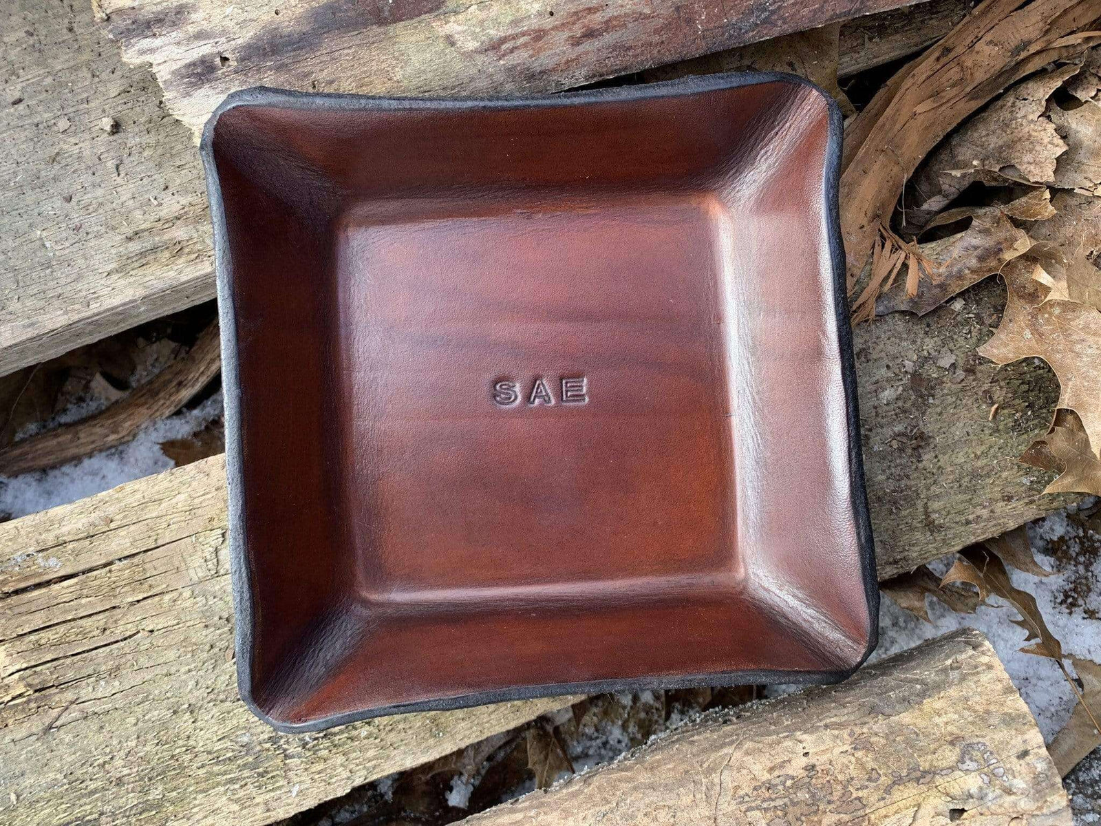 Leather valet with three letter monogram.