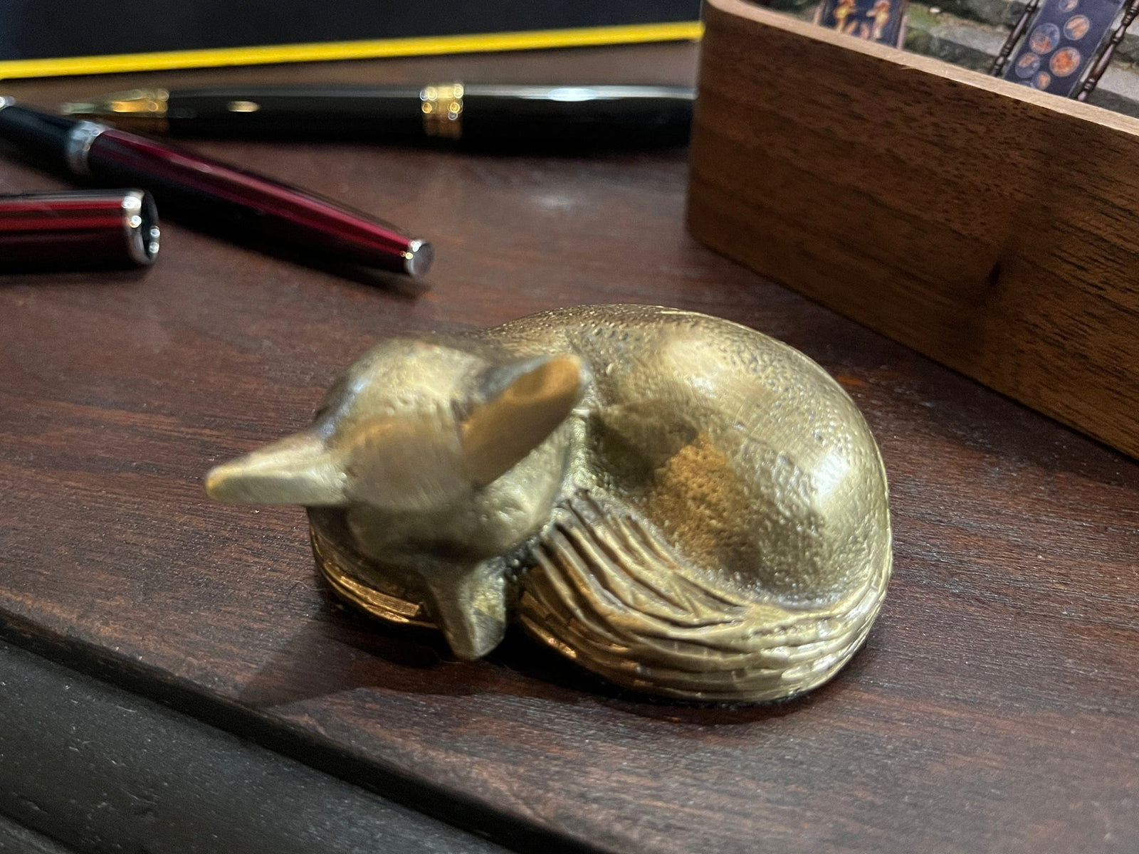 Small brass sleeping fox paperweight