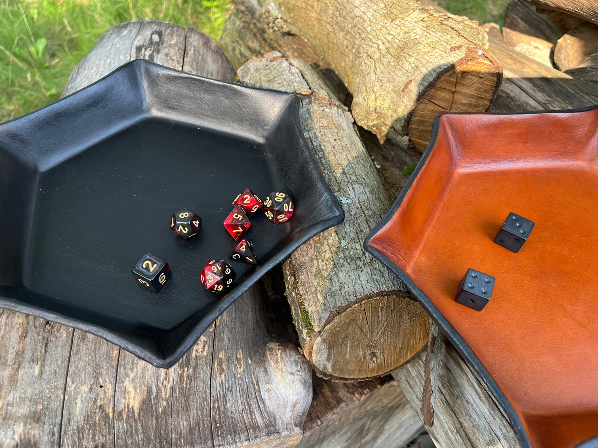 Black and Tan hexagonal leather trays shown with two different types of dice on a wooden surface