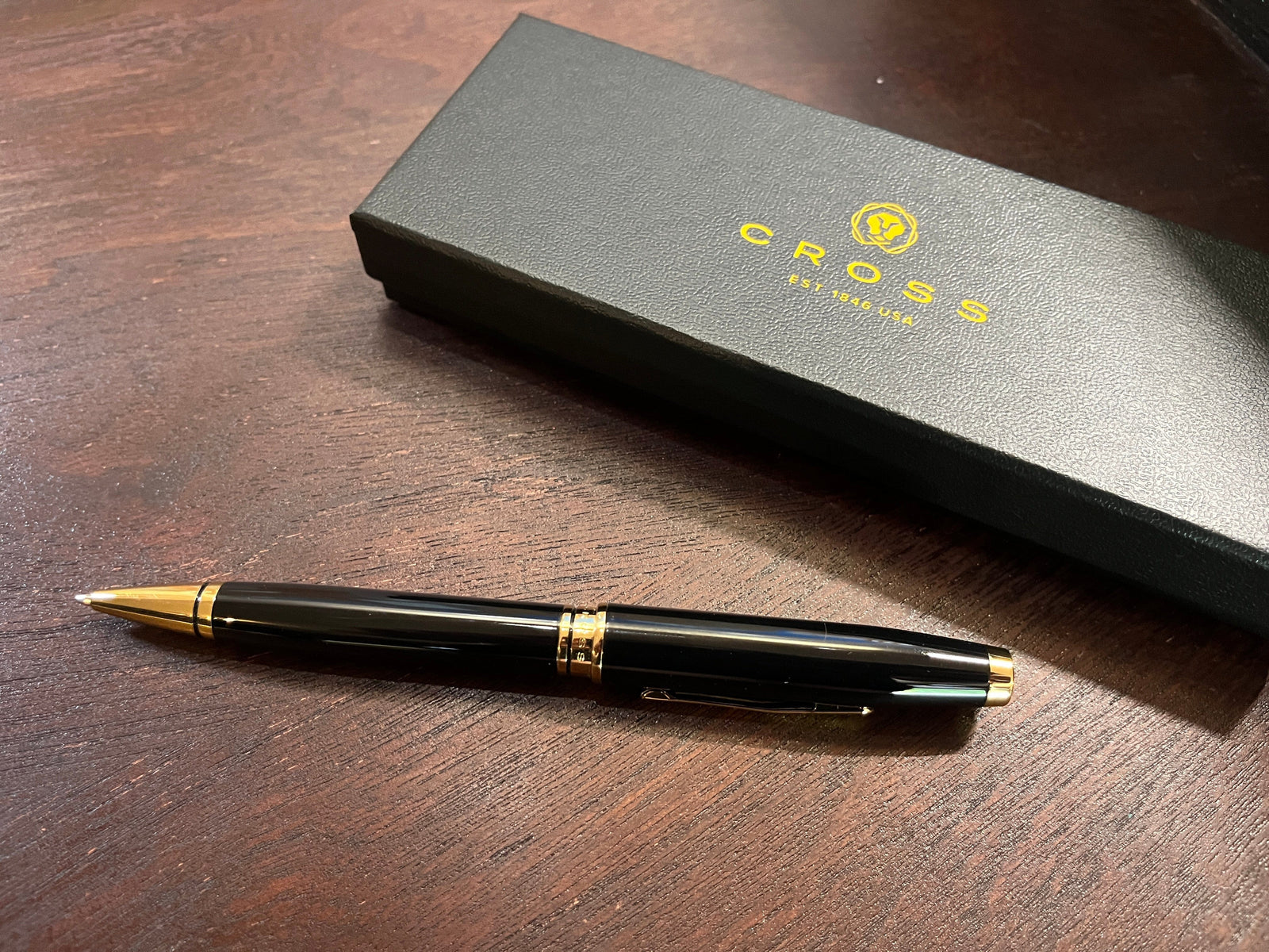 Cross black and gold ballpoint pen show with A.T. Cross branded box