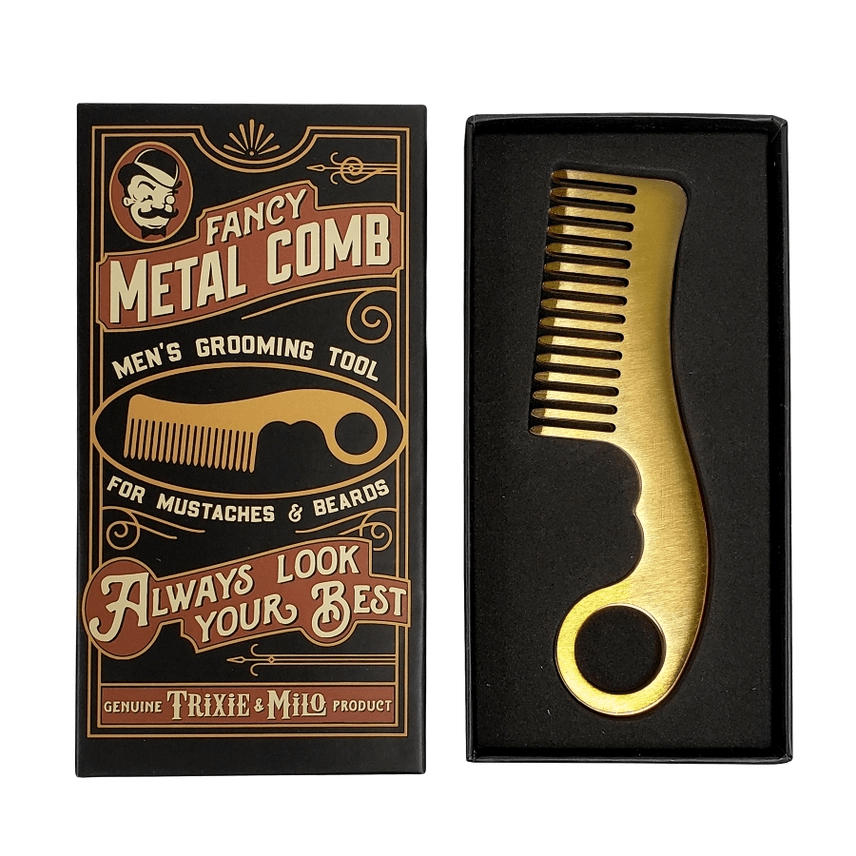 Gold metal comb in a decorative box with branding text