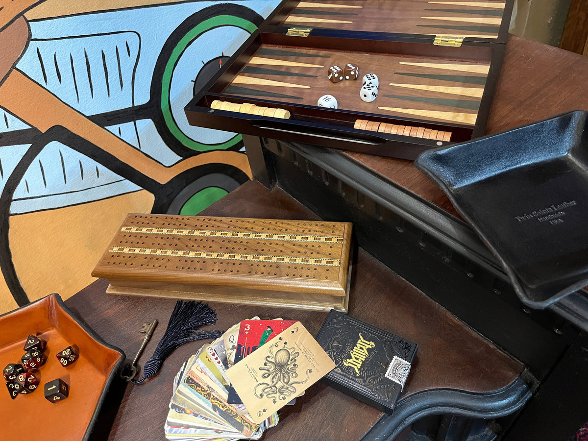 Desktop games and cards displayed on an desk sold by Twin Saints Leather