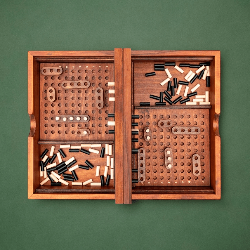 Wooden pegboard game with pegs on a green background