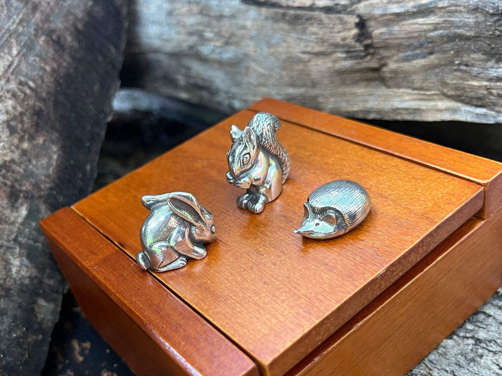 Set of three pewter forest animals shown with wooden keepsake box