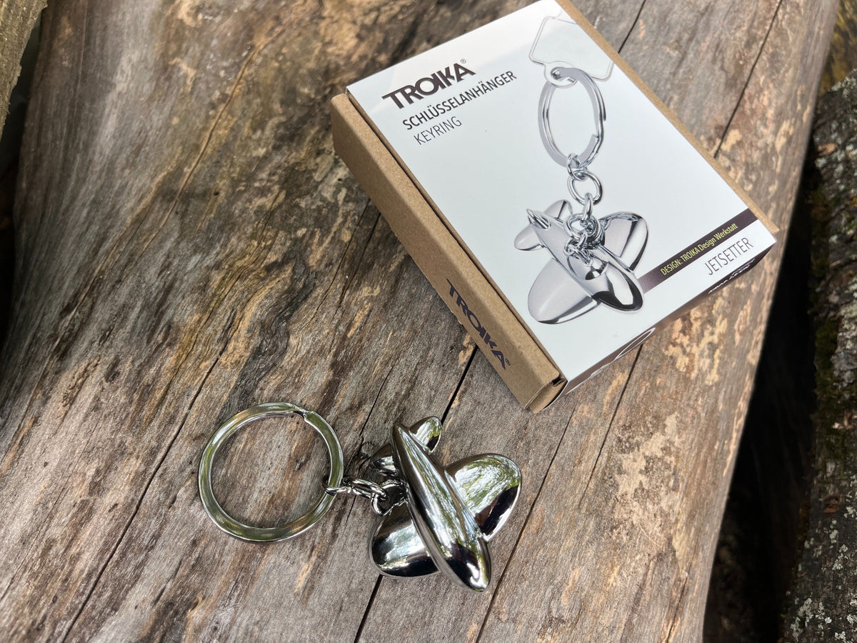 Jetsetter airplane keychain by Troika shown with product box