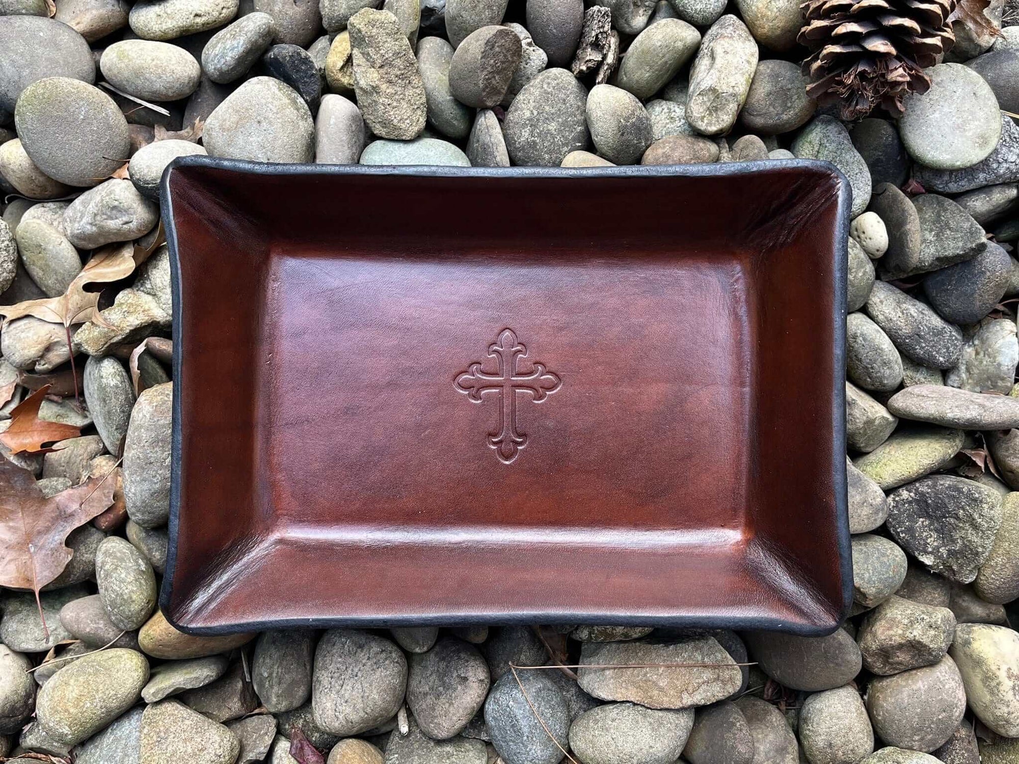 Rectangular leather valet tray with embossed cross. Brown