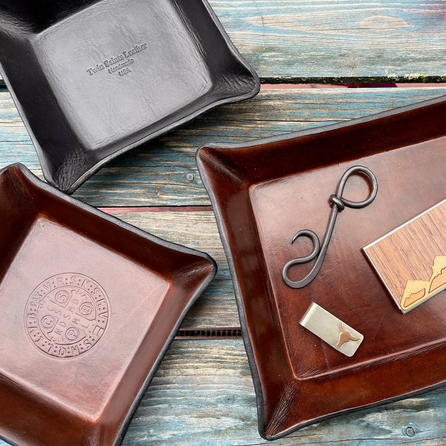 A selection of Twin Saints Leather trays and desk accessories