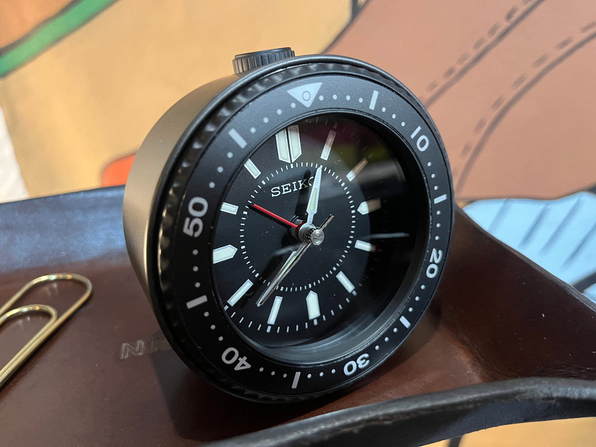 Seiko Mai alarm clock in black/black shown on a desk