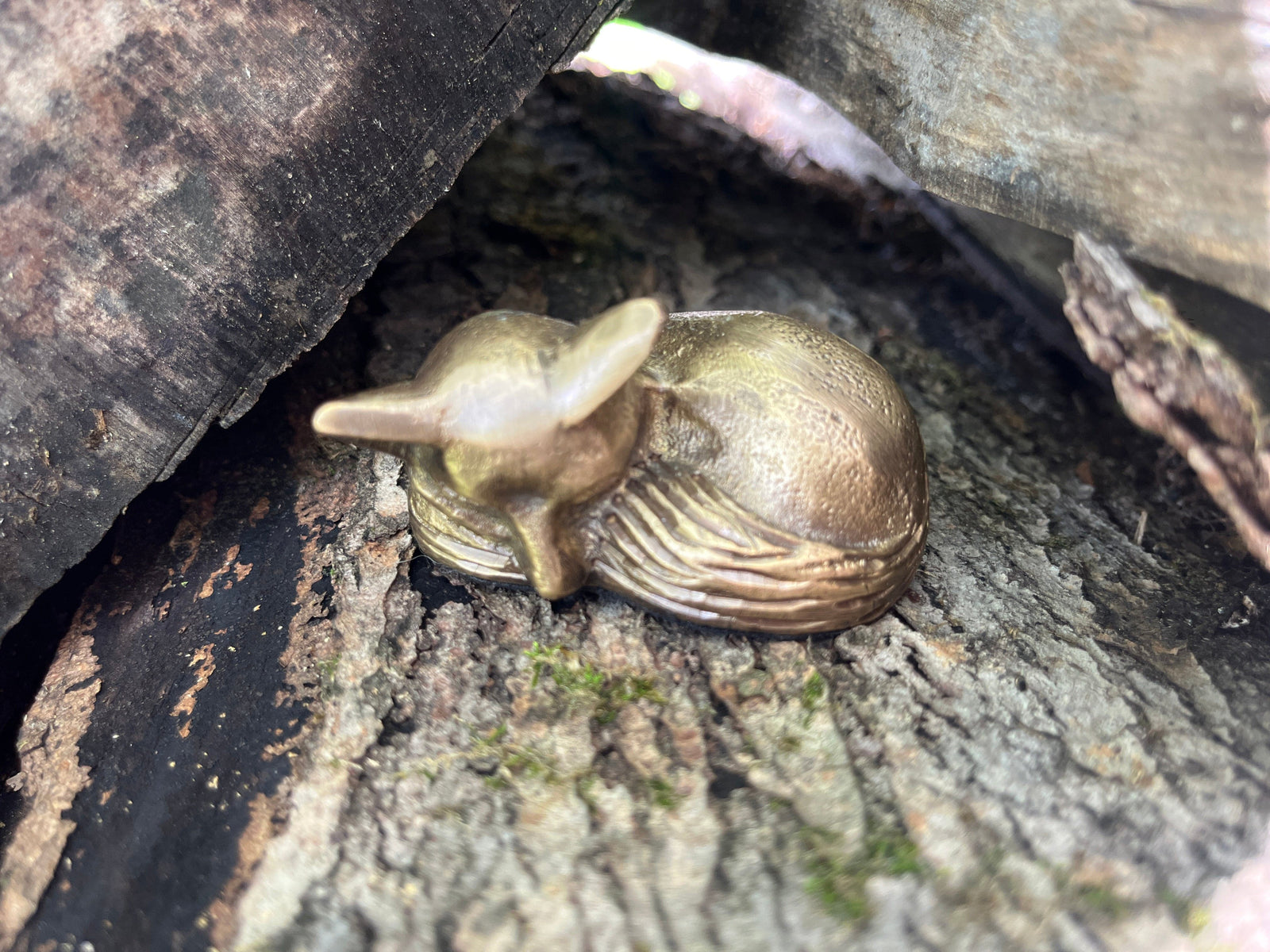 Small brass fox sculpture shown on a log