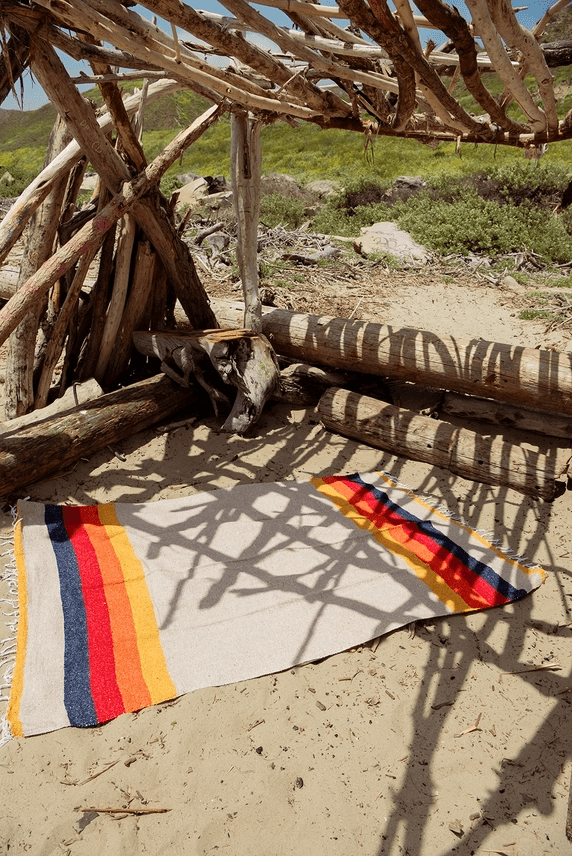 Sundream recycled throw with Tan Base, Yellow, Orange, Red, Navy.  Shown unfolded. 