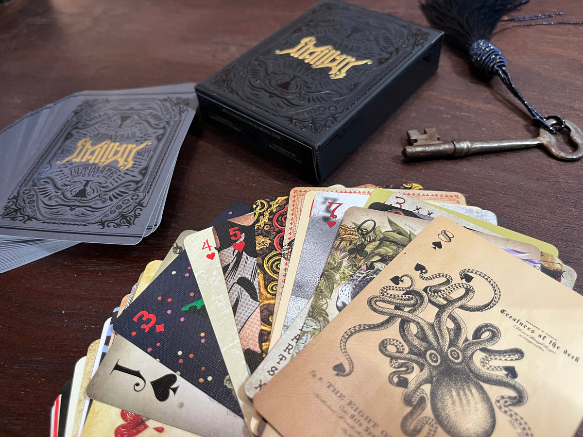 The Ultimate Deck art playing cards displayed on a desk
