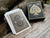 Black Artisan Playing cards with ornate designs on a wooden surface