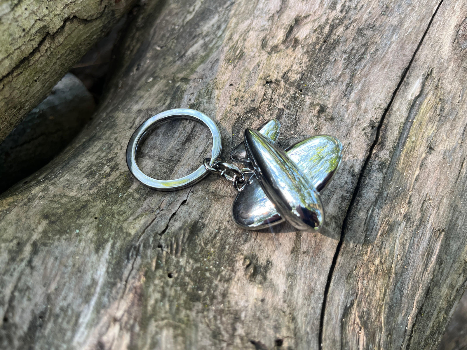 Troika Jetsetter Keychain shown on wood background