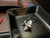 Troika Jetsetter cast airplane keychain shown in black leather desk tray