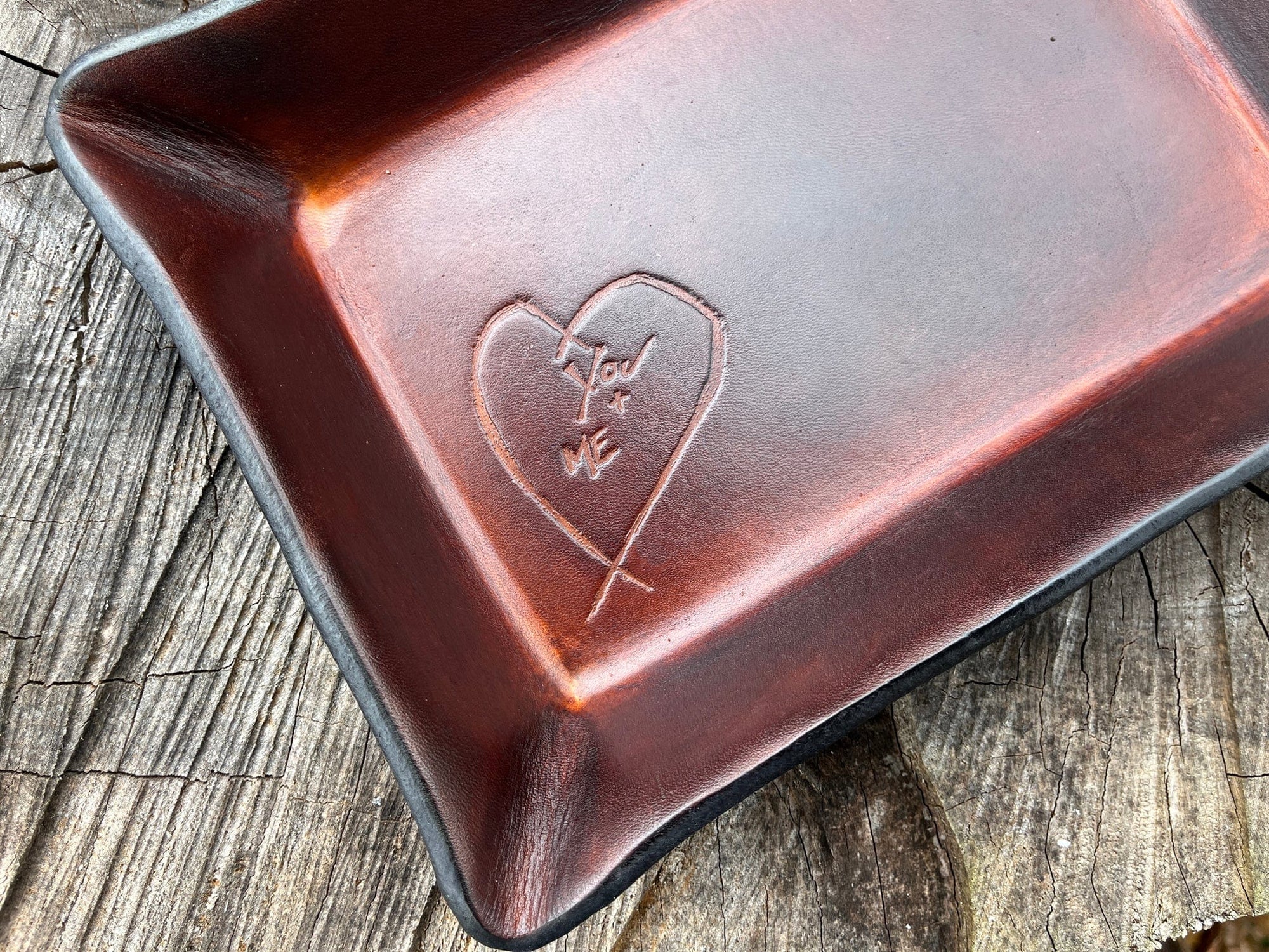 Detail of  third anniversary rectangular leather valet tray with embossed heart. 