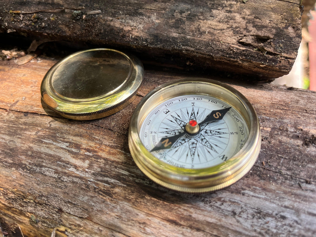 Solid brass magnetic compass with screw top lid. shown open.