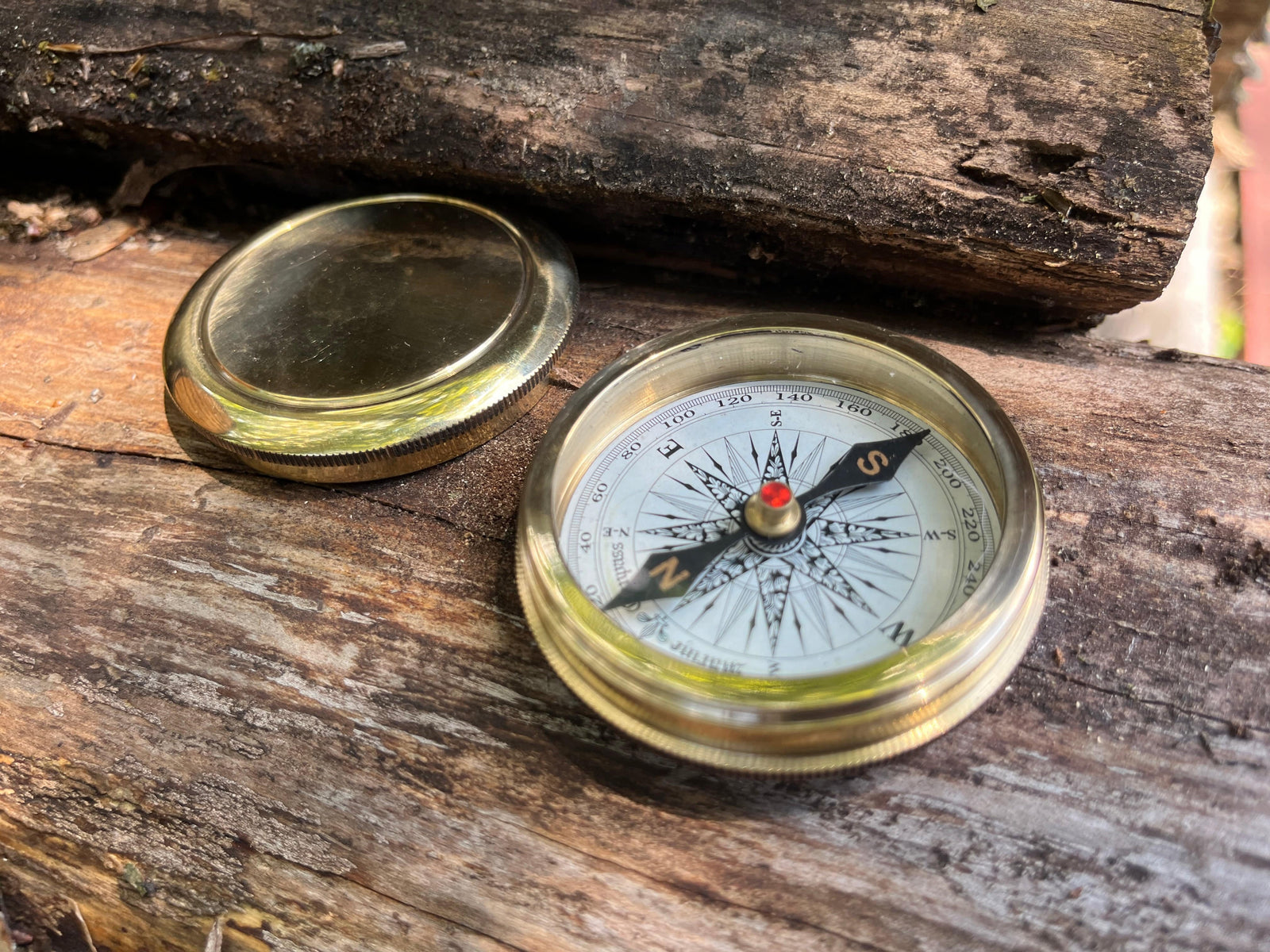 Solid brass magnetic compass with screw top lid. shown open.