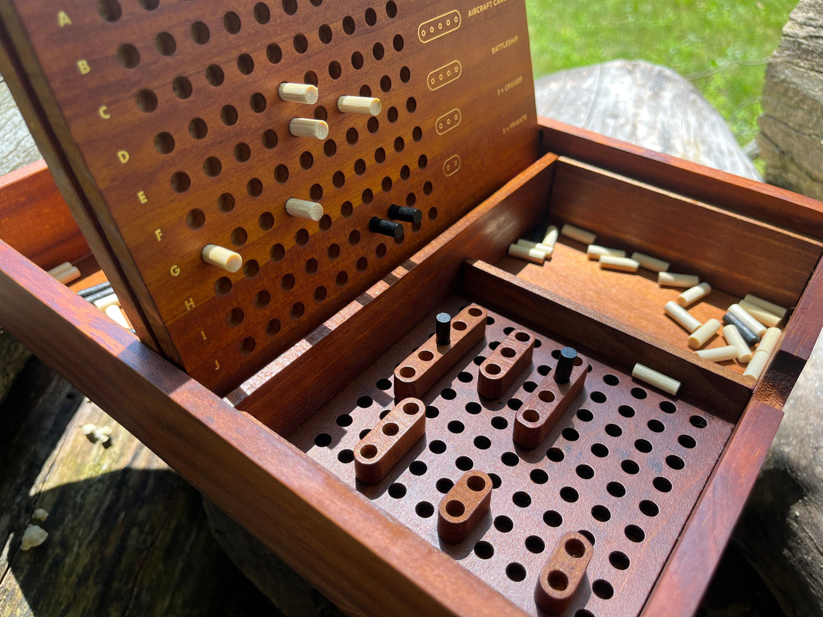 Wooden game board with pegs on a wooden surface