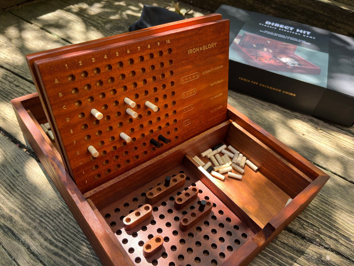 Wooden strategy game board with pieces on a wooden surface