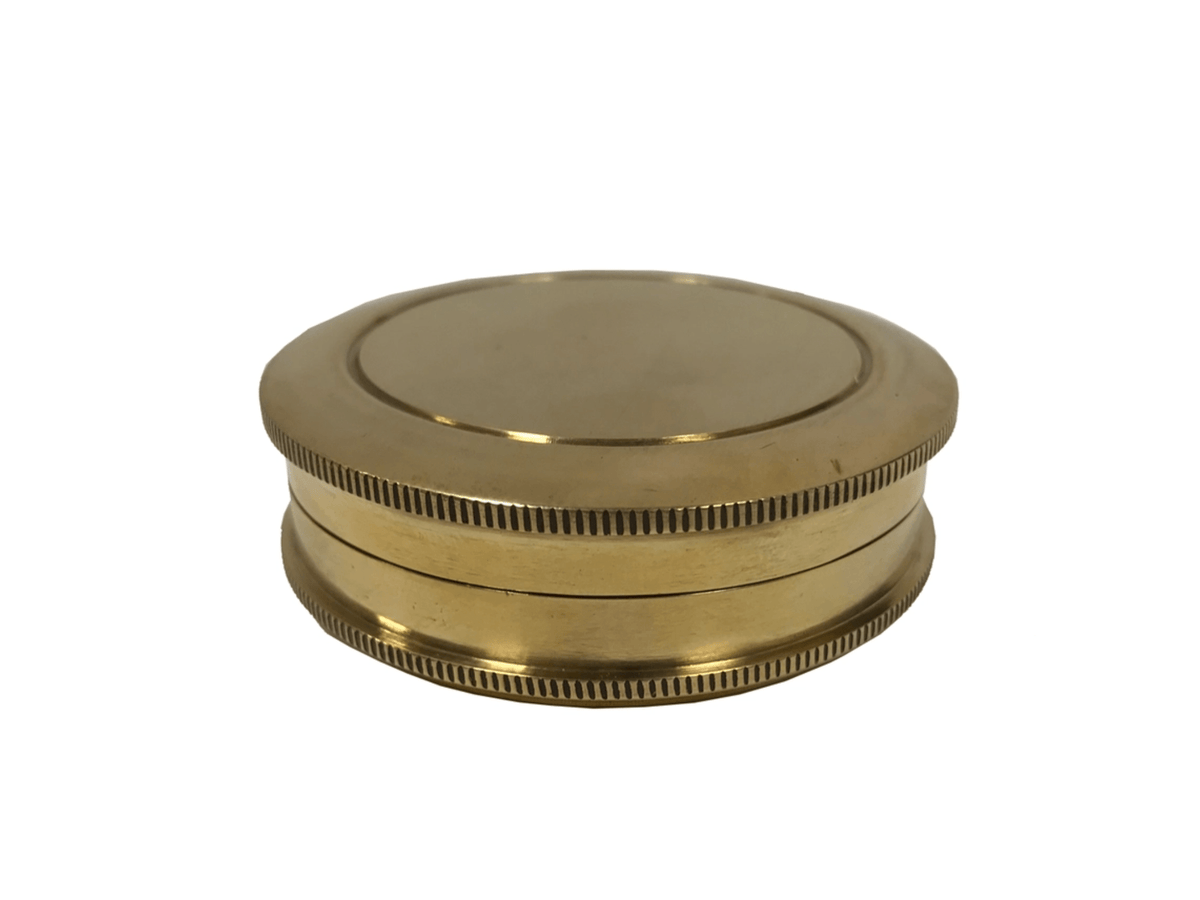 closed view of solid brass pocket compass with screw-on lid.