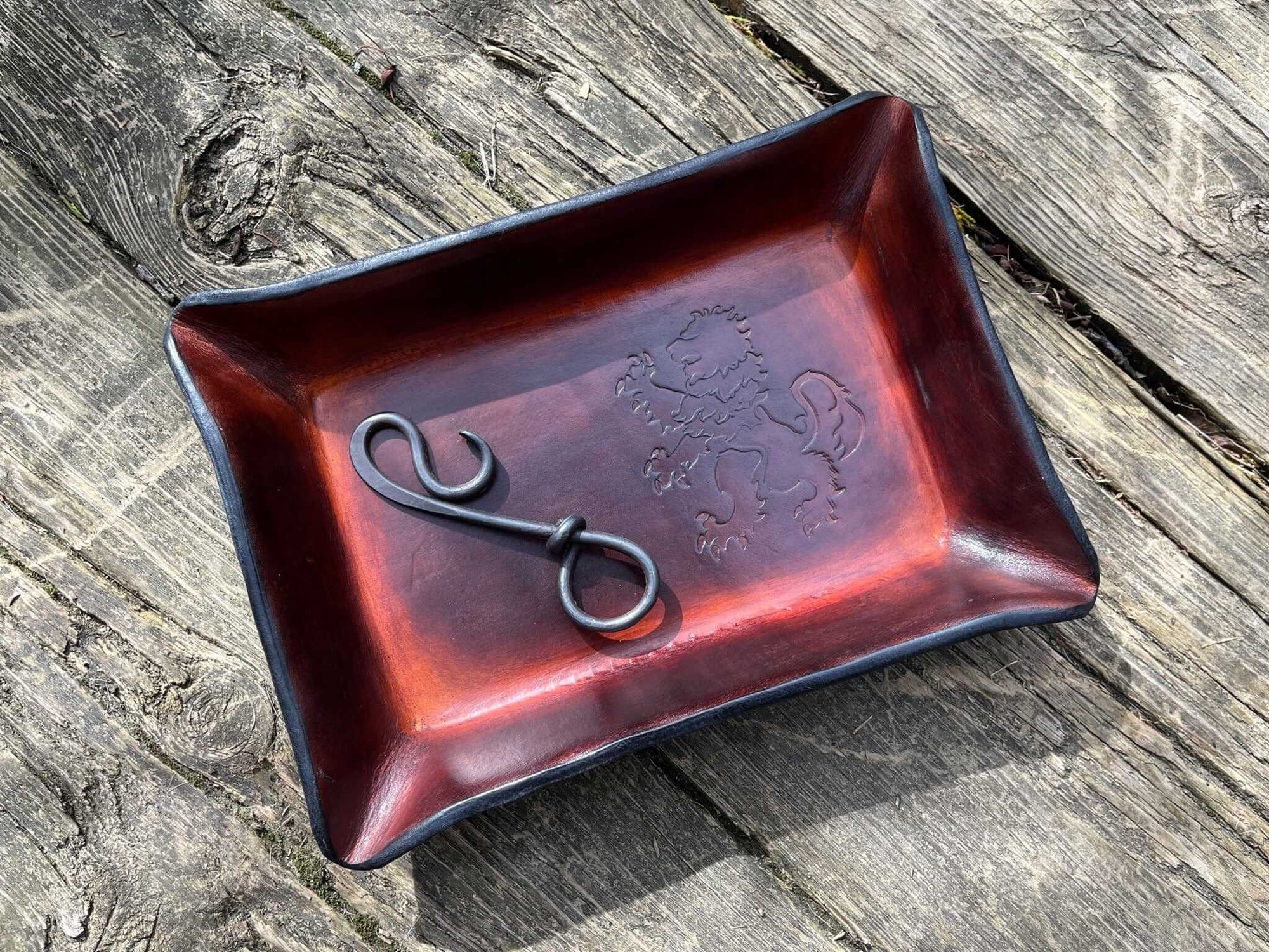 Rampant Lion leather tray shown with bottle opener keychain.