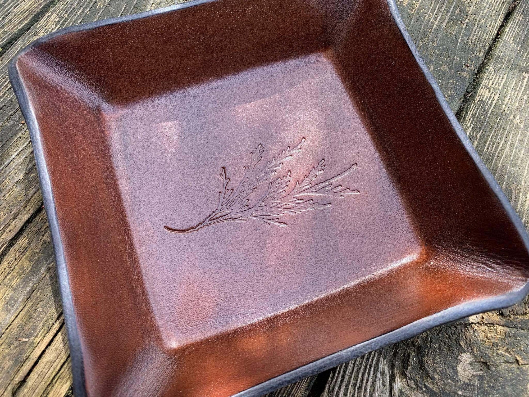Leather valet tray with cedar branch image. Detail.