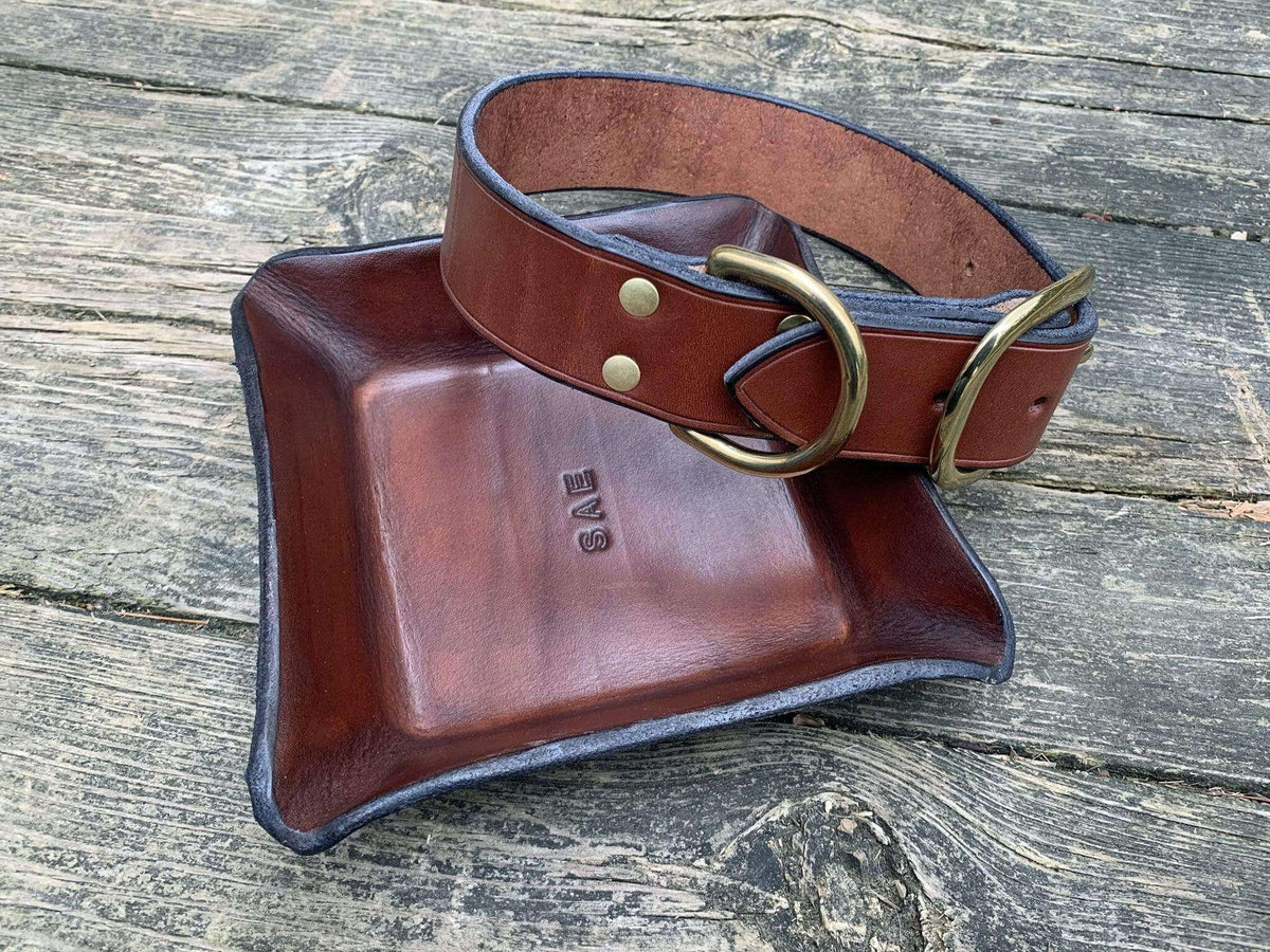 Brown leather dog collar and monogrammed leather valet tray. 