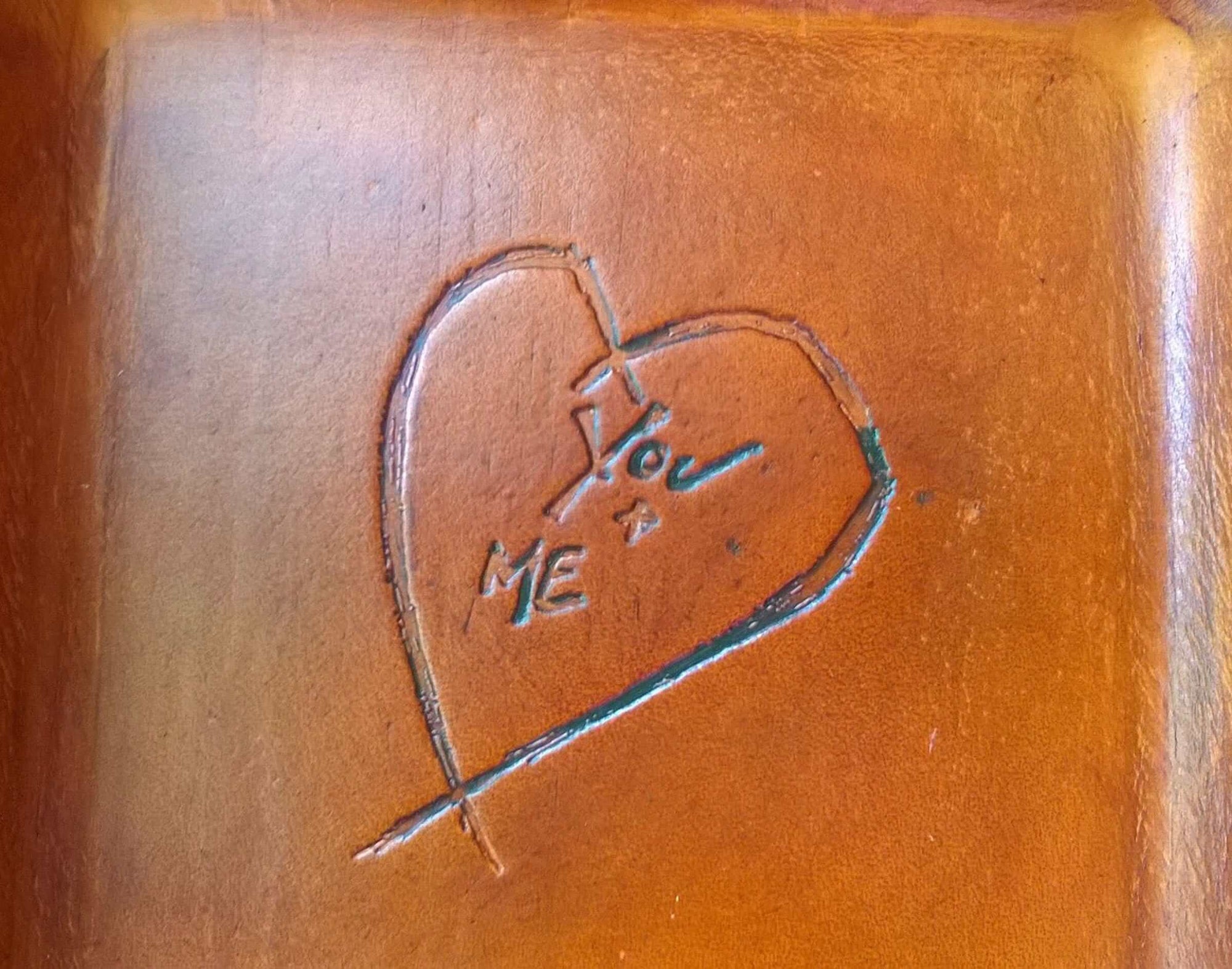 Detail of distressed heart leather tray. 